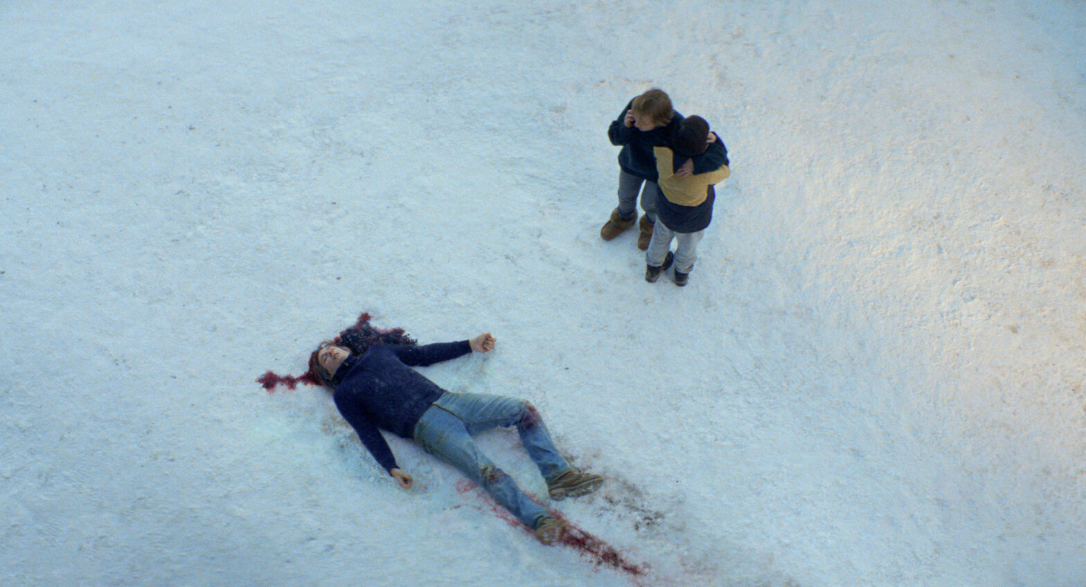 Sandra Hüller and Milo Machado Graner standing over Samuel Theis dead body.