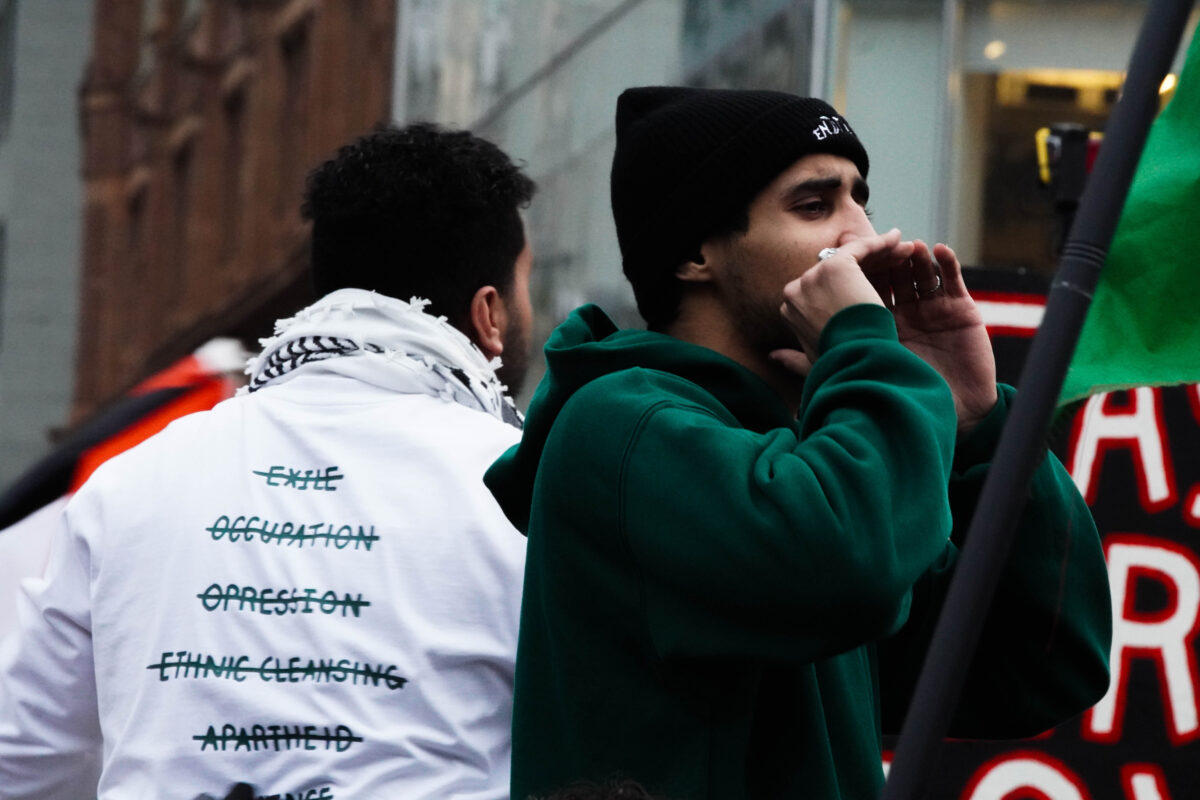 two protesters leading chants for crowd