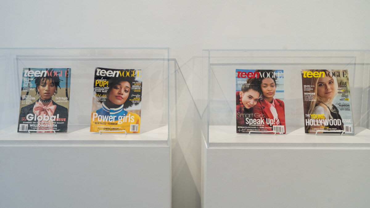 Four Teen Vogue magazine covers are displayed in two glass cases. The left case features covers with Willow Smith for "The Global Issue" and Amandla Stenberg for the "Power Girls" issue. The right case features covers with Rowan Blanchard and Yara Shahidi for "Smart Girls Speak Up!" and Elle Fanning for "The Young Hollywood Issue.”