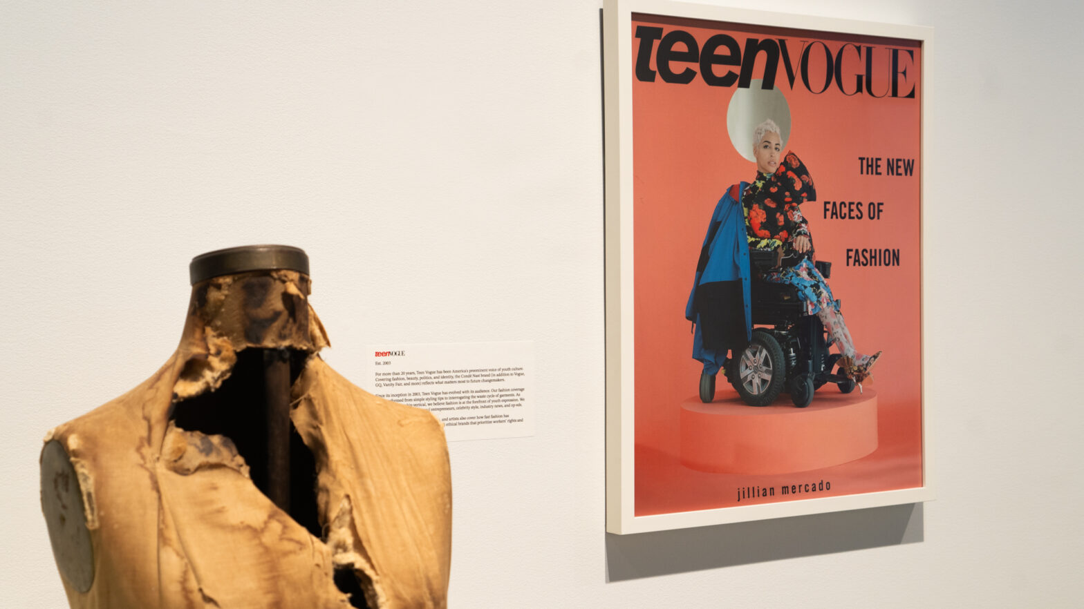 Alt text: A distressed, worn out mannequin beside a Teen Vogue cover featuring a model seated in a wheelchair, with the headline “The New Faces of Fashion” against a white background.