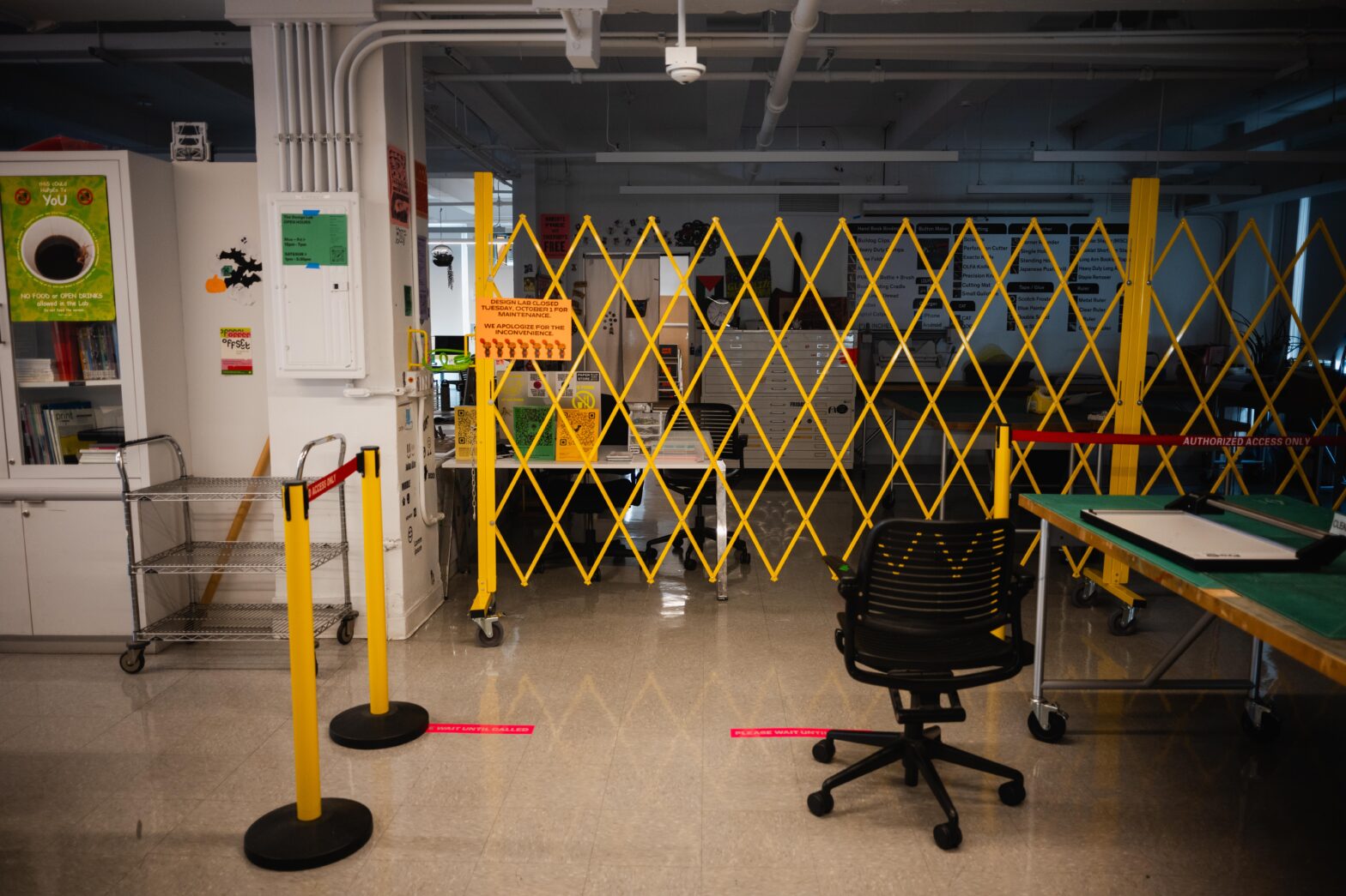 The Design Lab, a studio for digital production, is closed by a yellow gate.