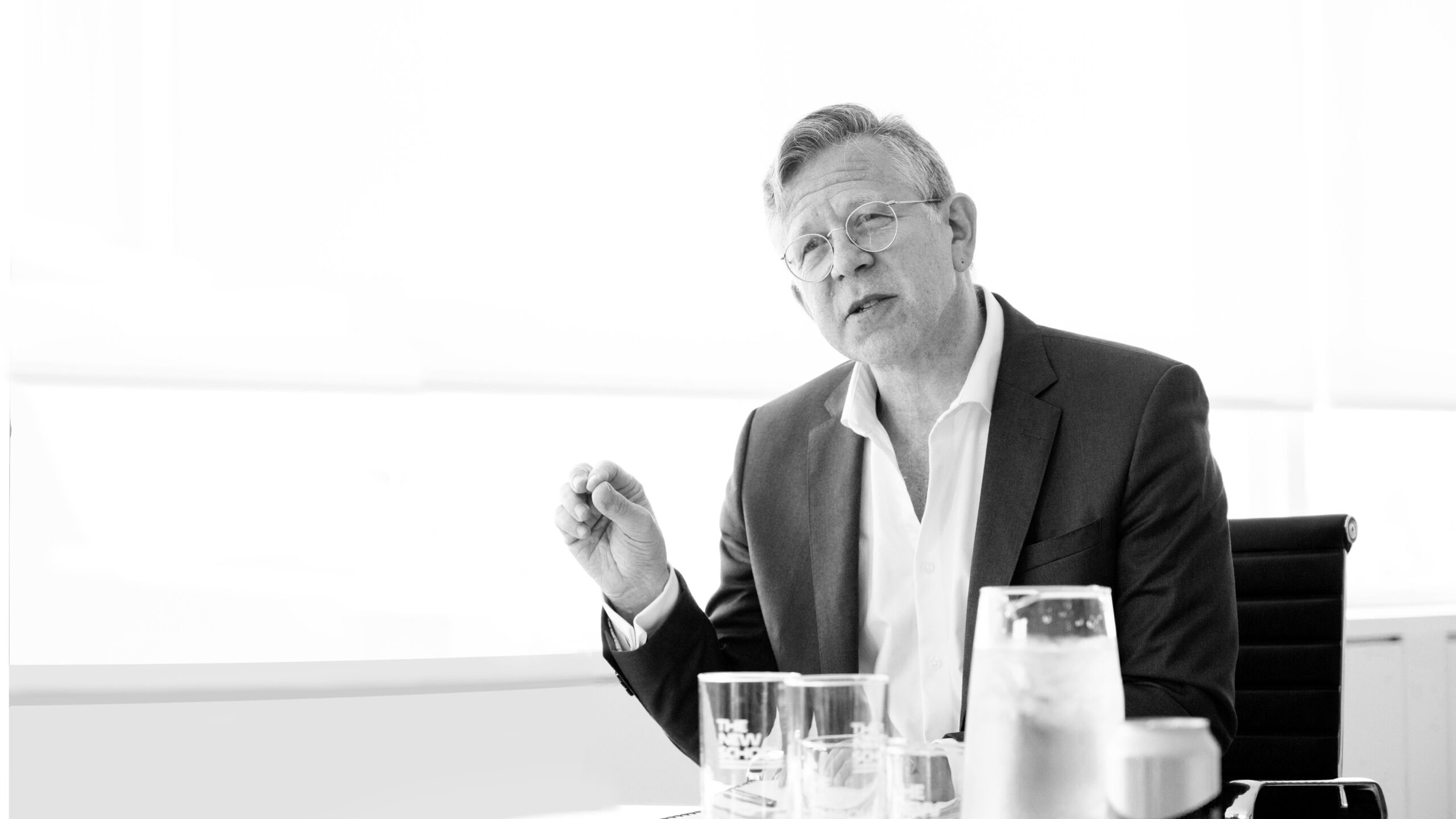 President Joel Towers sitting in his office, in black and white.