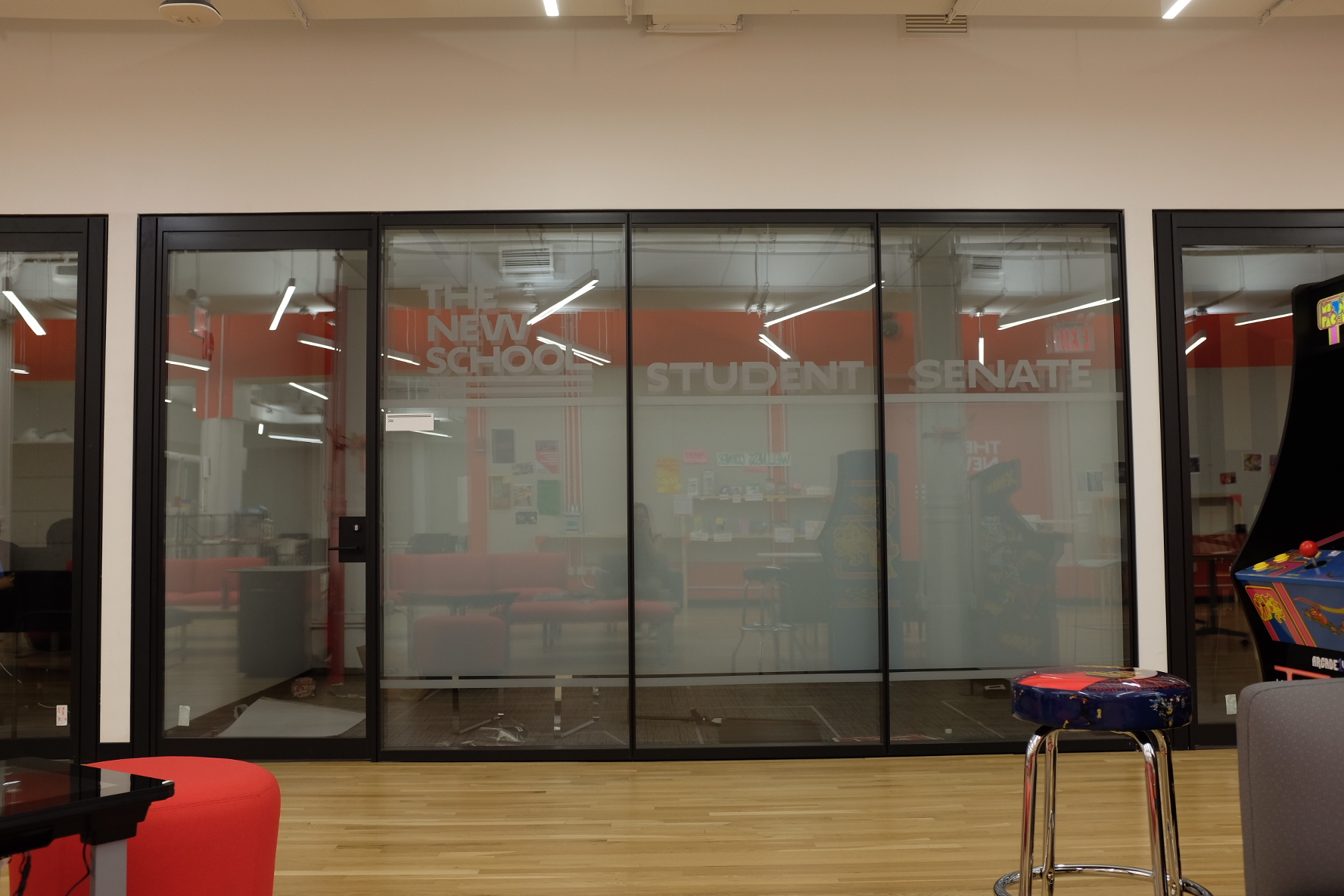 Student Senate room in the 39 W 13th street building, with the words "University Student Senate" on glass windows.