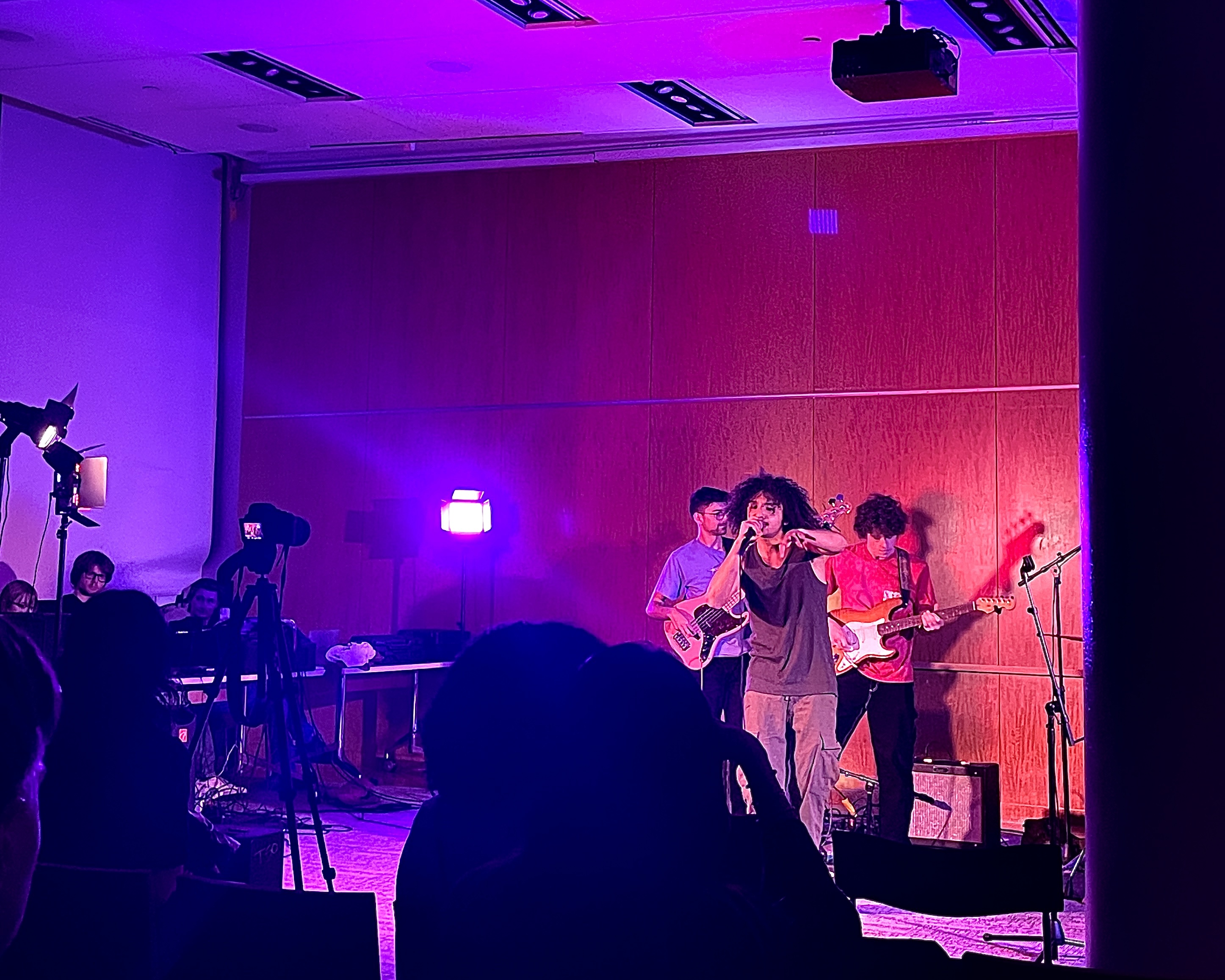 Nory and band mid-rap perform on purple lit stage using guitar and microphone