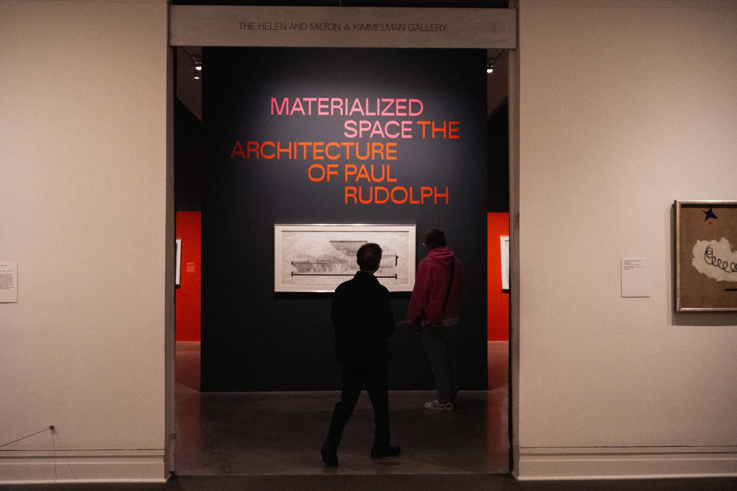 An opening looking into a gallery space titled “Materialized Space: The Architecture of Paul Rudolph.”