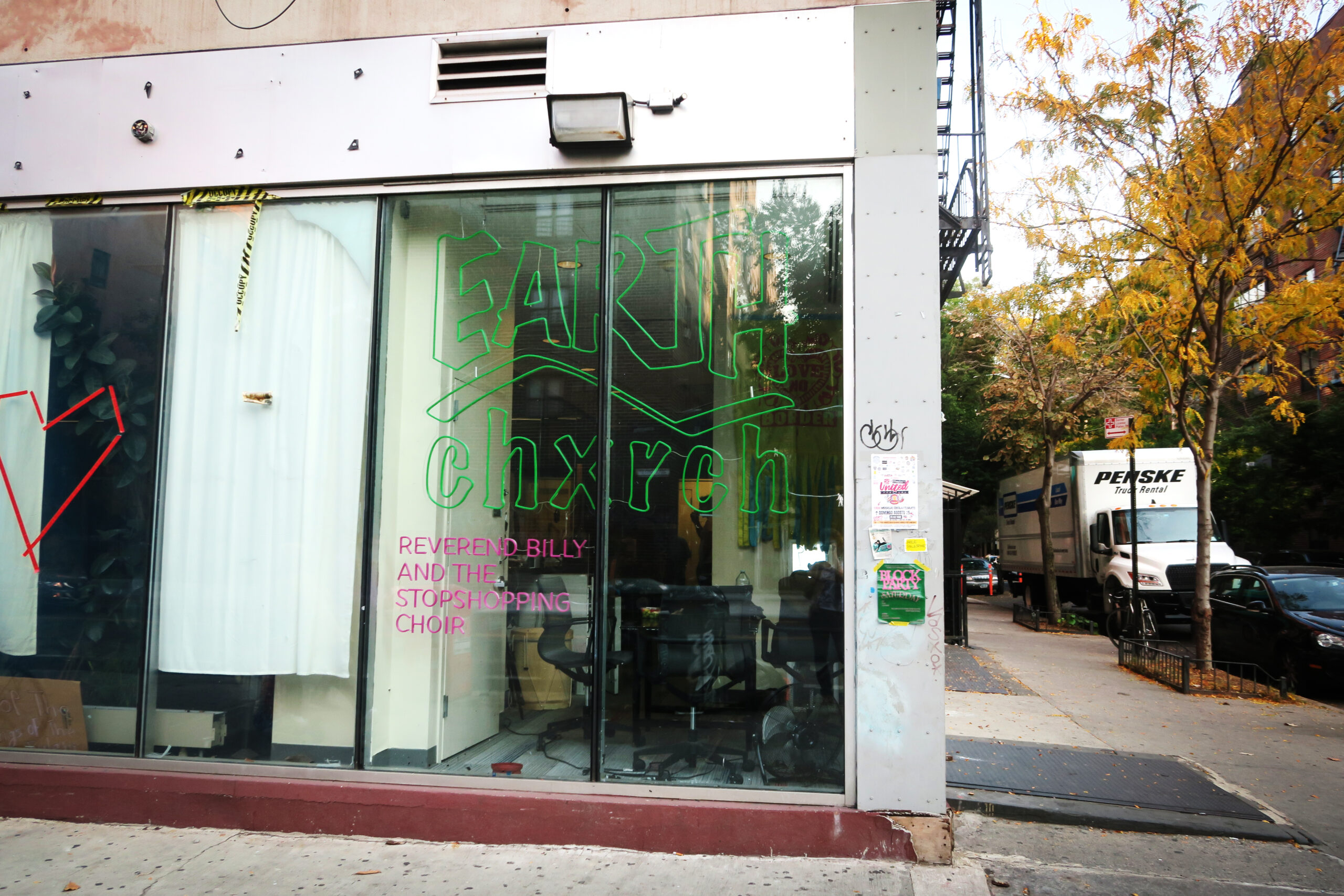 The Earth Chxrch’s logo in their community space at the corner of 3rd street and Avenue C, with the writing “Earth Church, Reverend Billy and the Stopshopping Choir.”