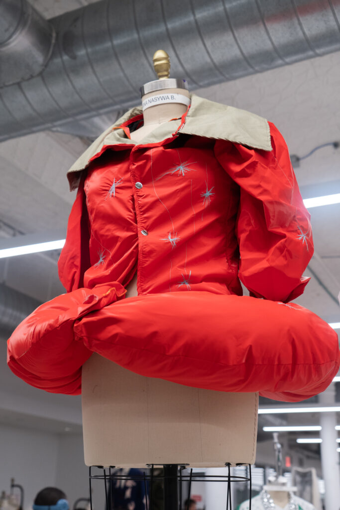 Mannequin with red trench-coat like garment.