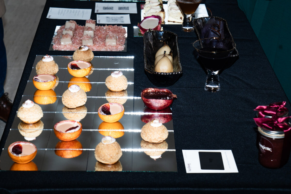 An arrangement of citrus pastries on a black table. 