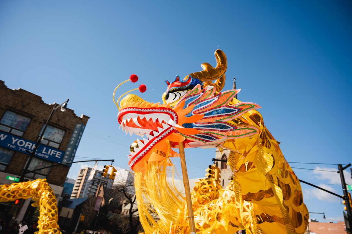 A yellow dragon puppet rears its head.