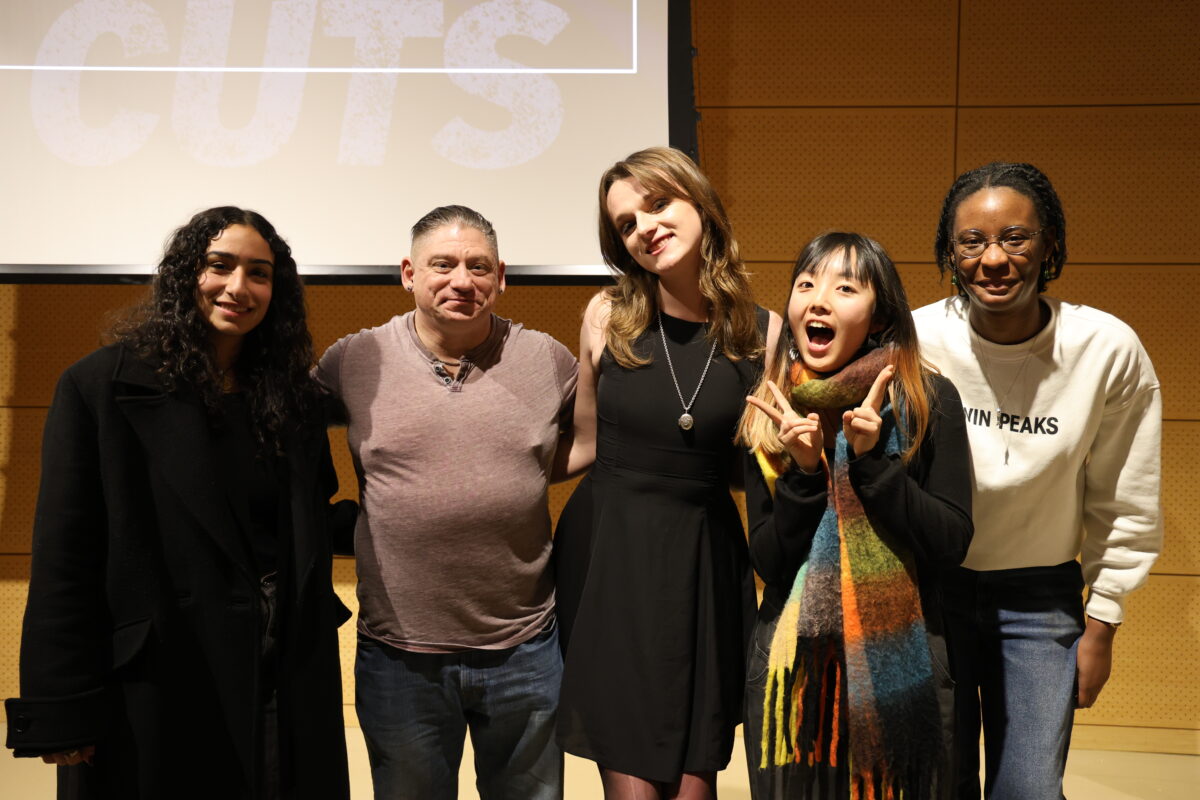 Alt text: Five people posing and smiling for the camera.